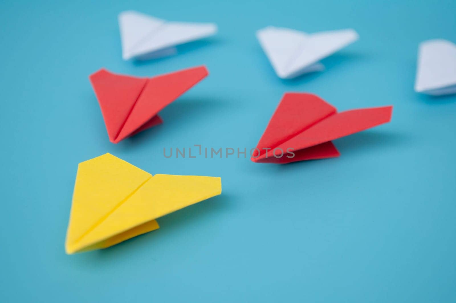 Top view of yellow paper airplanes with space for text.