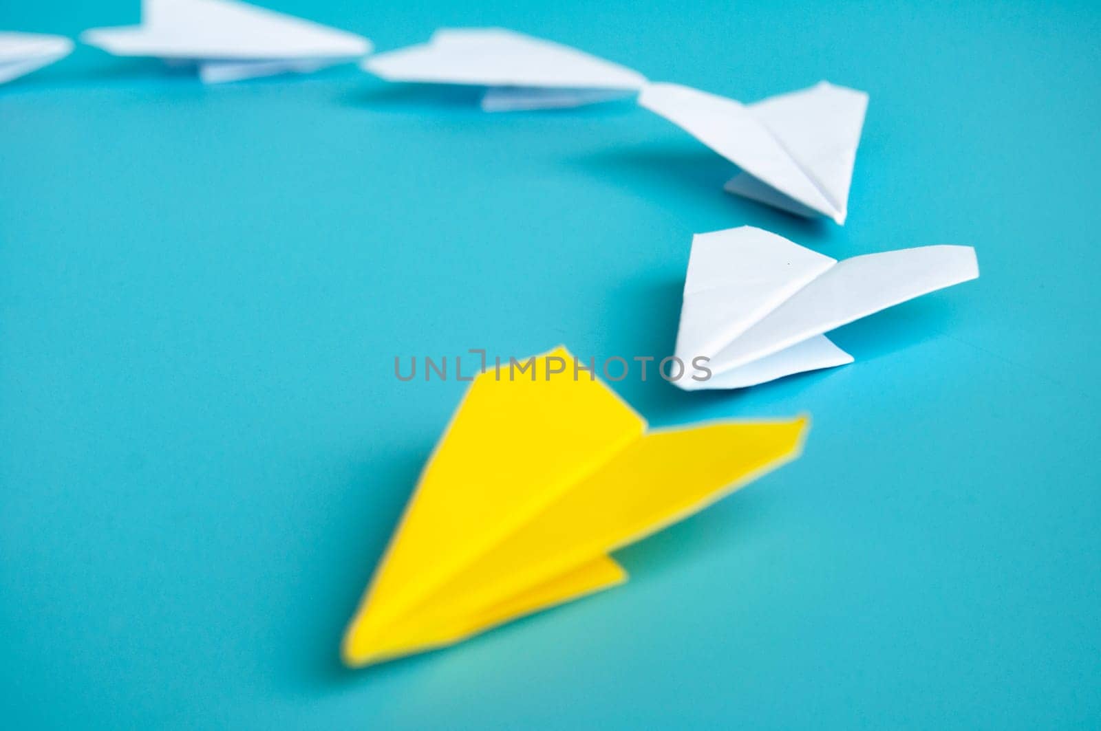Top view of yellow paper airplanes with space for text.