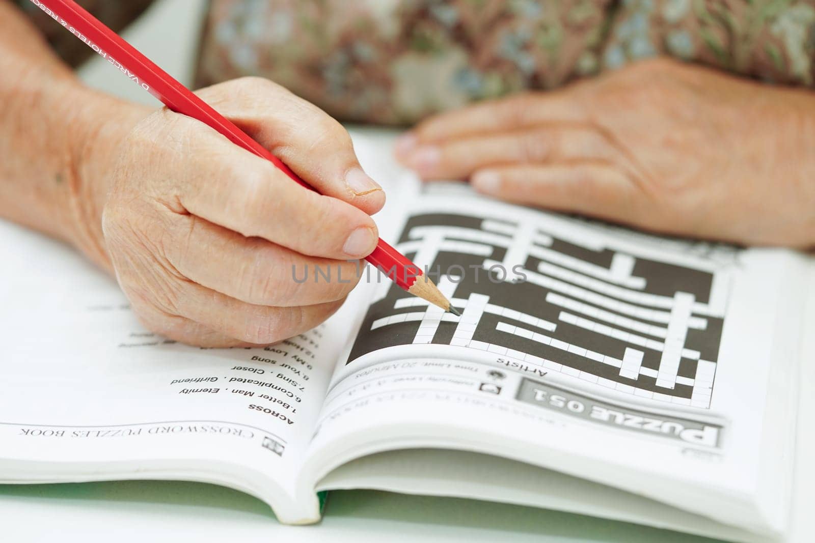 Bangkok, Thailand - May 15, 2022 elderly woman playing sudoku puzzle game for treatment dementia prevention and Alzheimer disease.