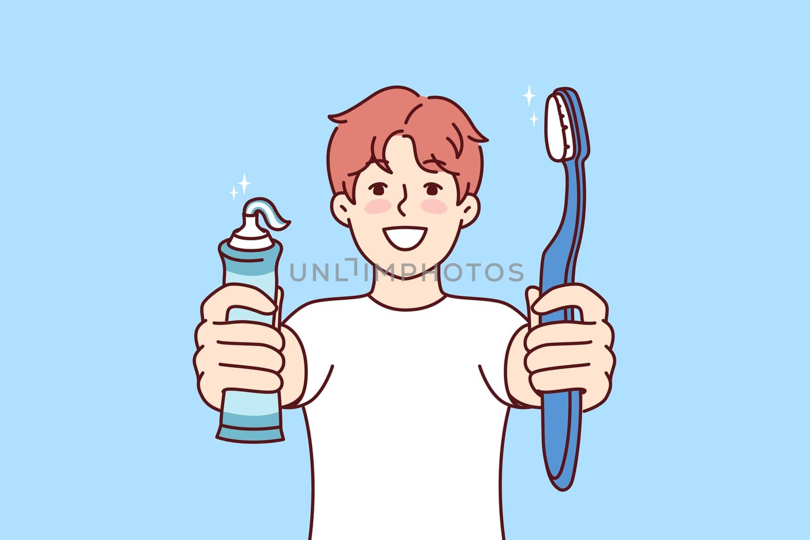 Little boy holds toothpaste and toothbrush showing snow-white smile and recommending brushing teeth regularly. Child independently monitors health of own teeth in order to get rid of caries