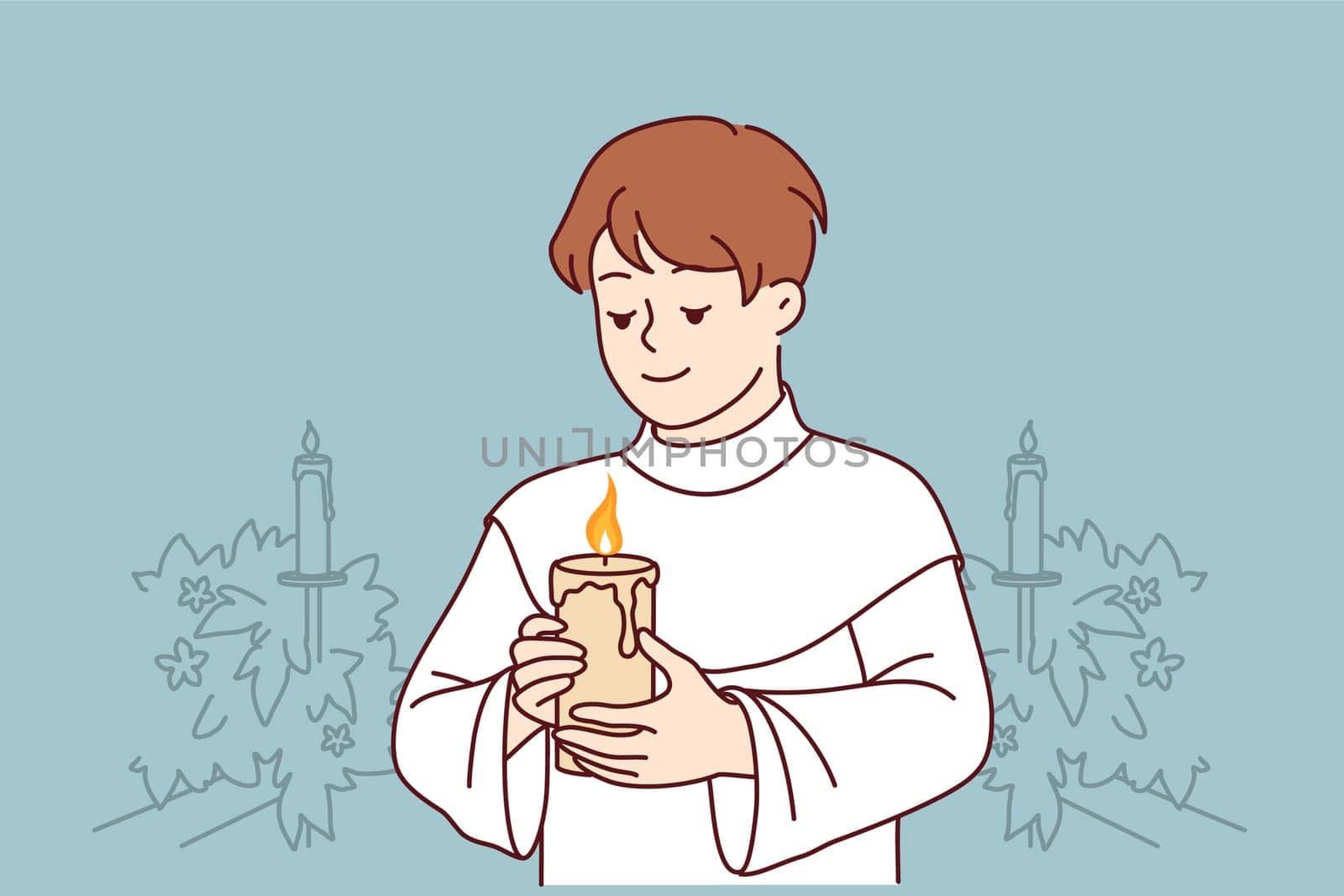 Boy participates in holy communion and holds burning candle for christian religious ritual in church. Child in clothes for communion ceremony in church smiles, wanting to become true believer catholic