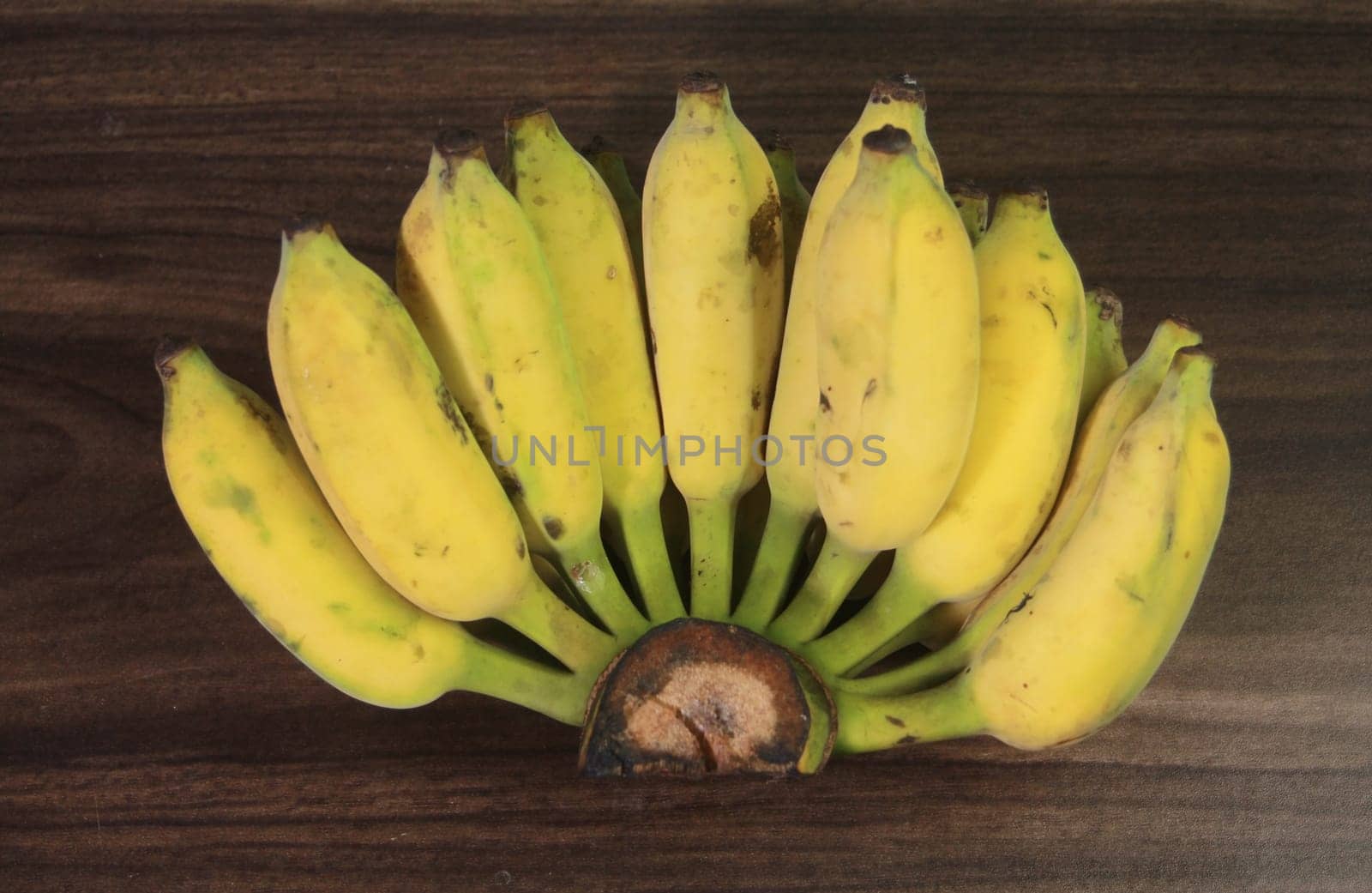 Banana fruit with wooden table on blurred background