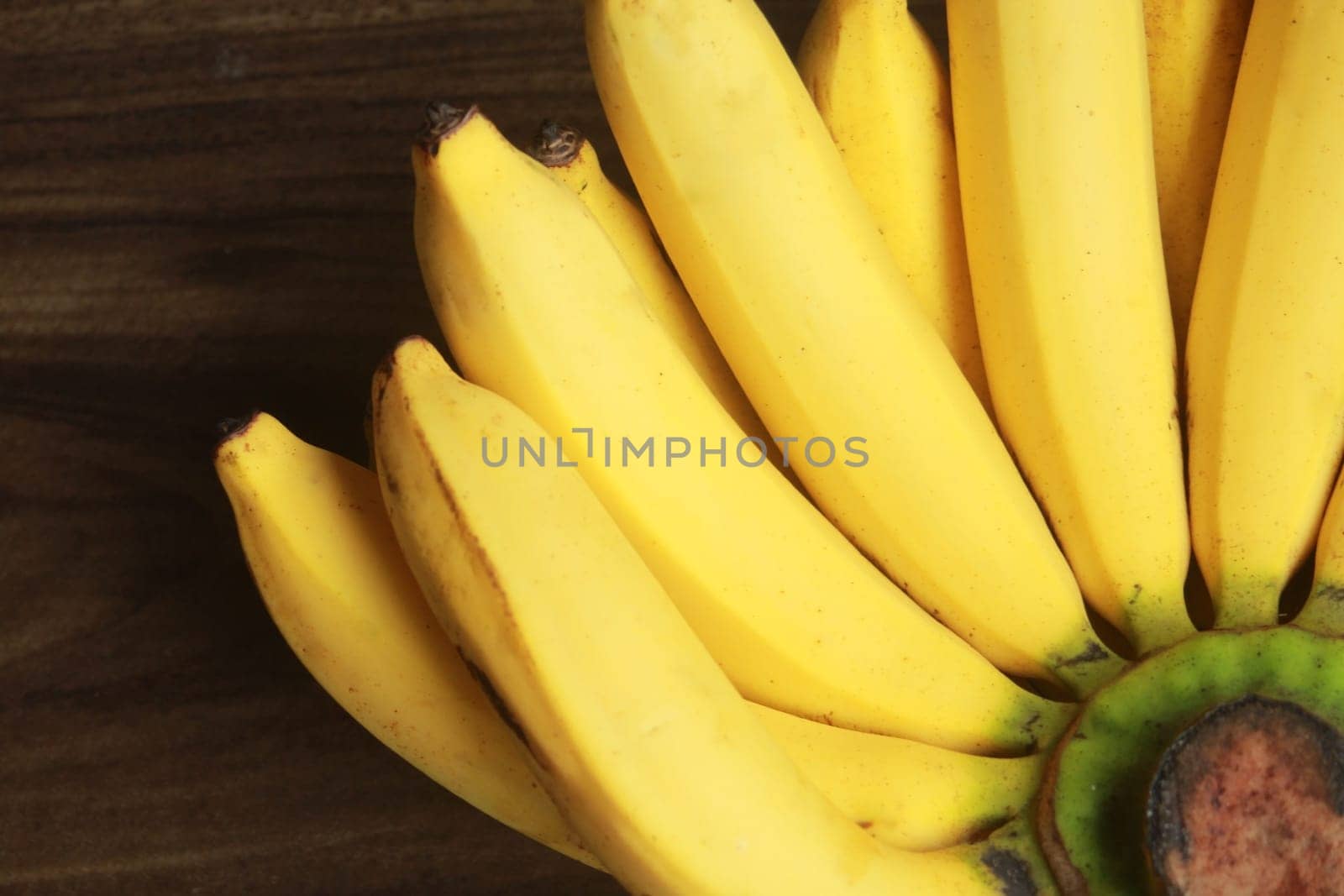Banana fruit with wooden table on blurred background