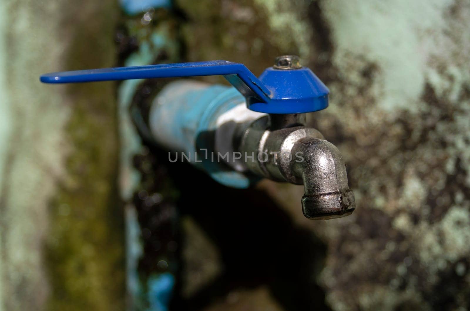Wasting water - water drop from water tap, Leaky or tap, water tap in toilet and bathroom, Deteriorated and dirty tap that everyone in the village uses to drink, which is located in a remote area It reflects the insufficiency of government agencies' water supply and the low quality of life of people in remote areas