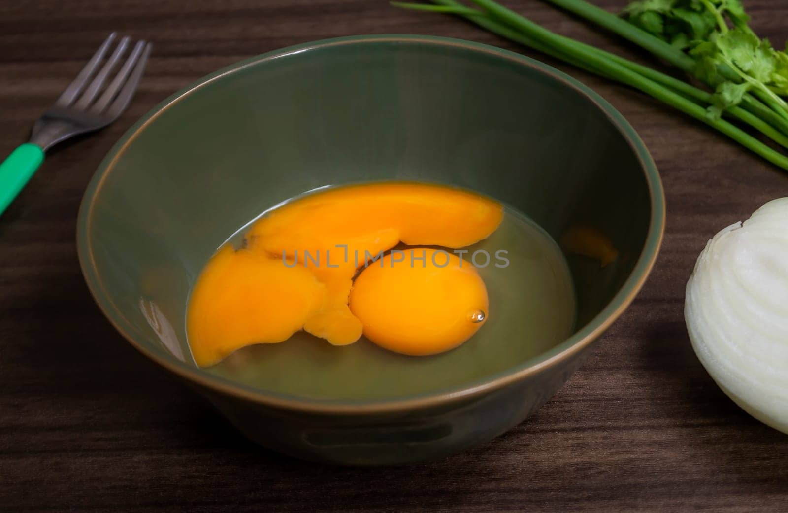 Fresh natural eggs in a bowl with spring onions and coriander to prepare for fried eggs, Omelettes, Egg yolk, Traditional dishes of rural people in Thailand