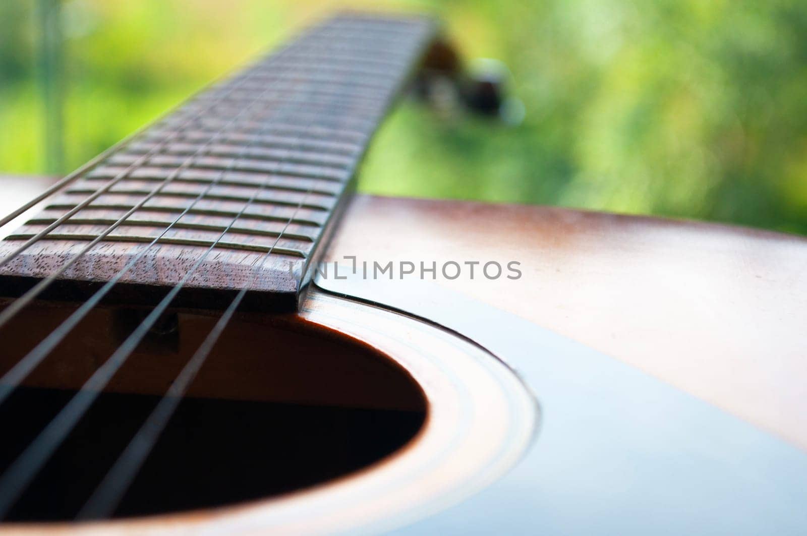 Close up of Guitar with nature background. Customizable space for text or ideas. Copy space.
