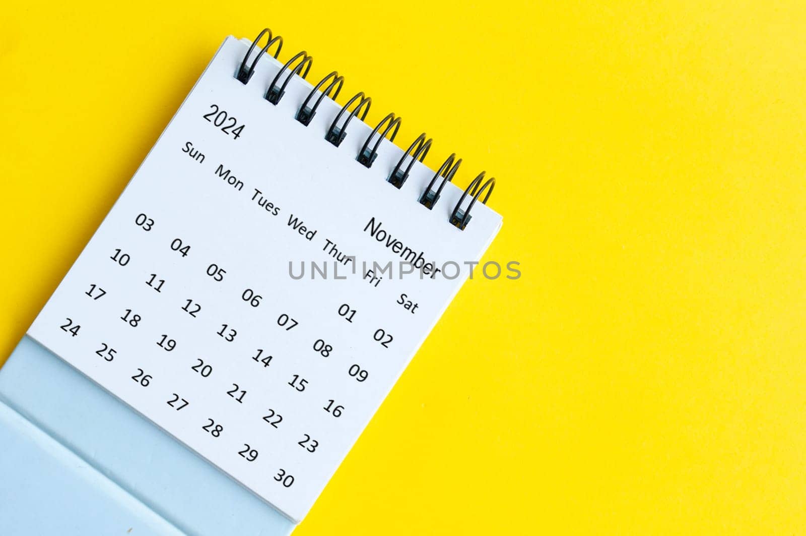 November 2024 table calendar on yellow cover background with customizable space for text