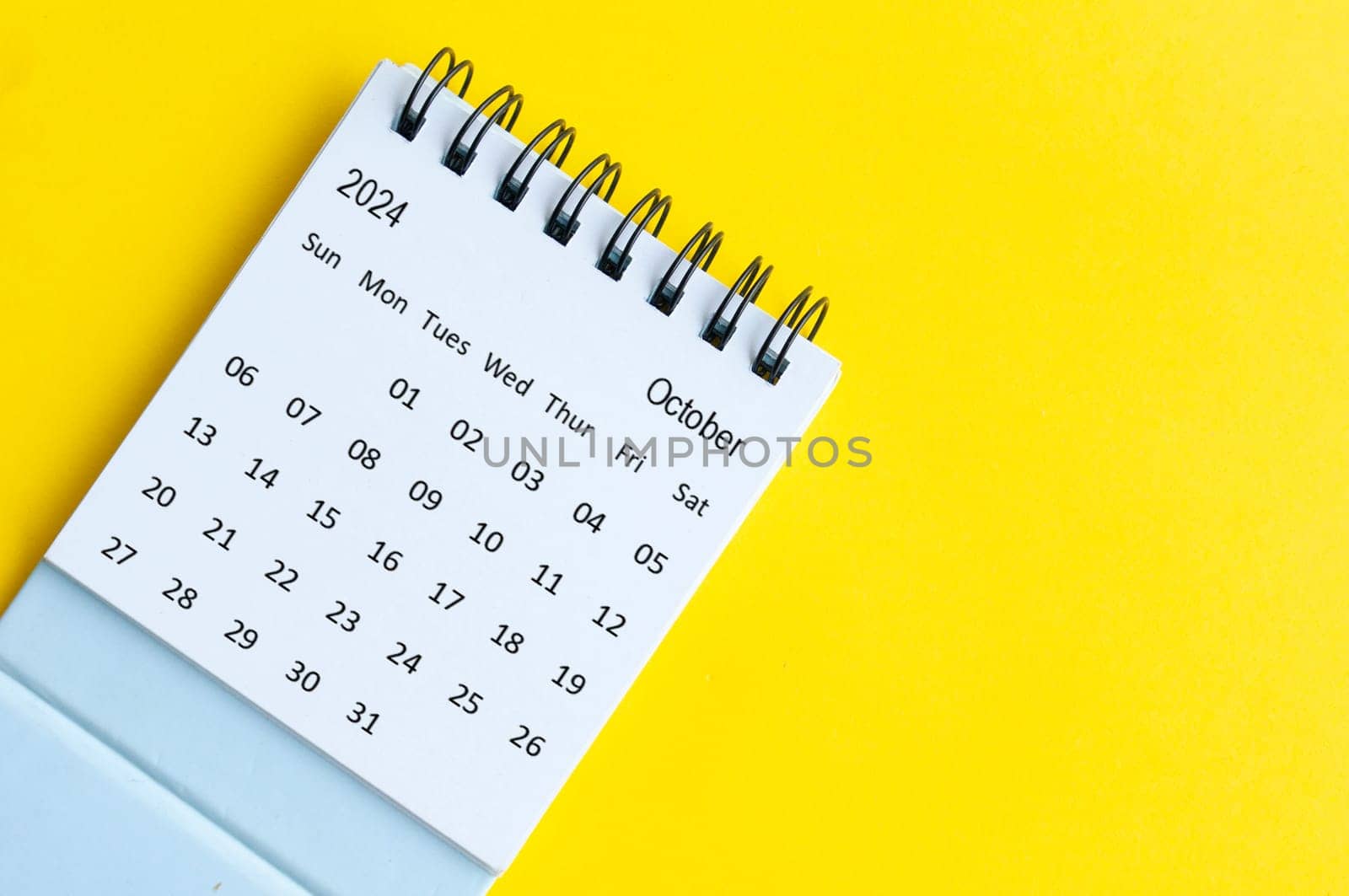 October 2024 table calendar on yellow cover background with customizable space for text