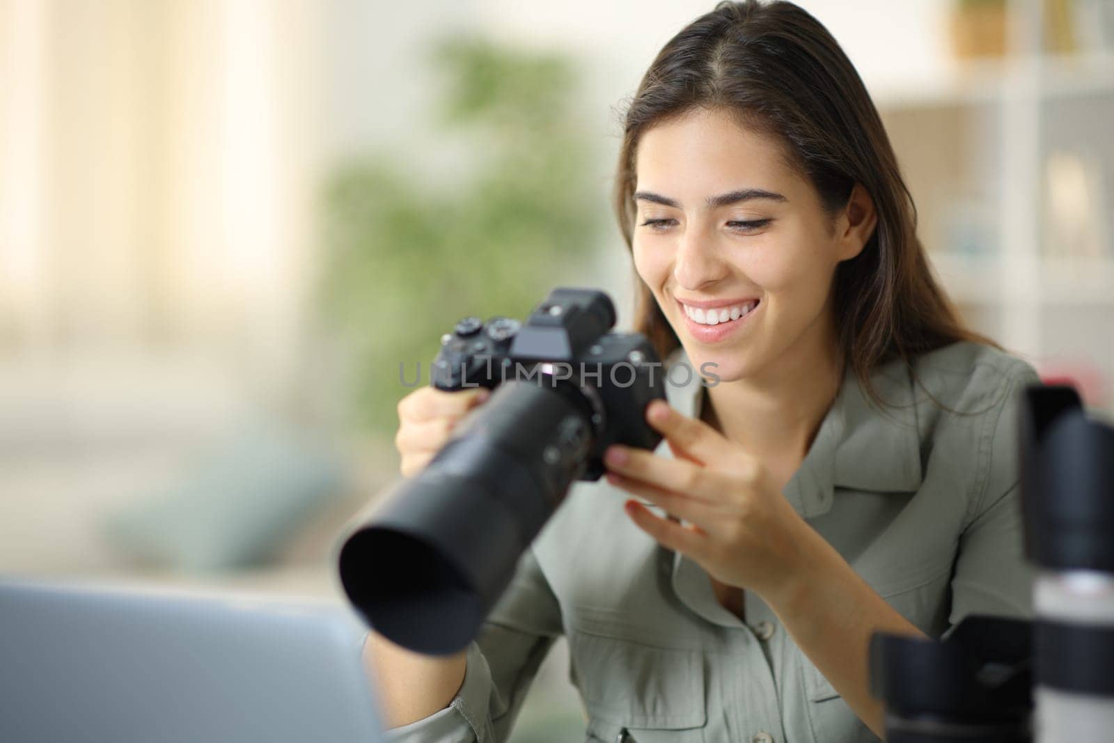 Happy photographer at home checking result on mirrorless camera