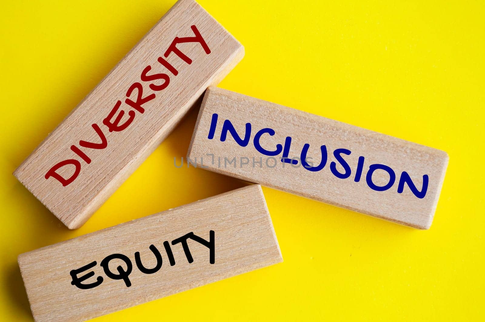 Top view of close up wooden blocks with text - Diversity, inclusion and equity. Diversity concept