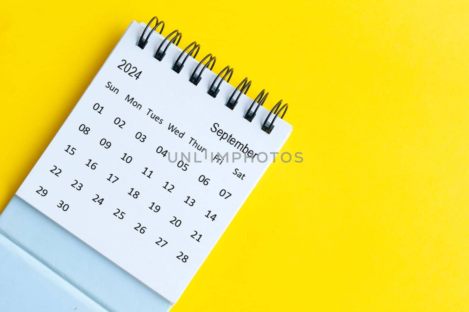 September 2024 table calendar on yellow cover background with customizable space for text