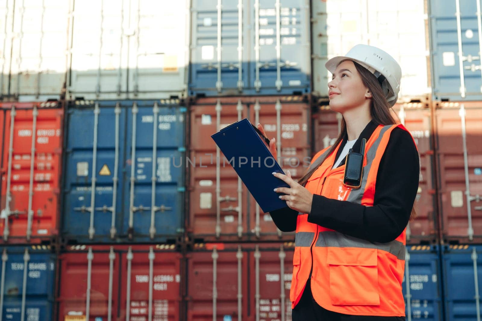 Woman Works in international shipping area Export and import delivery service with containers