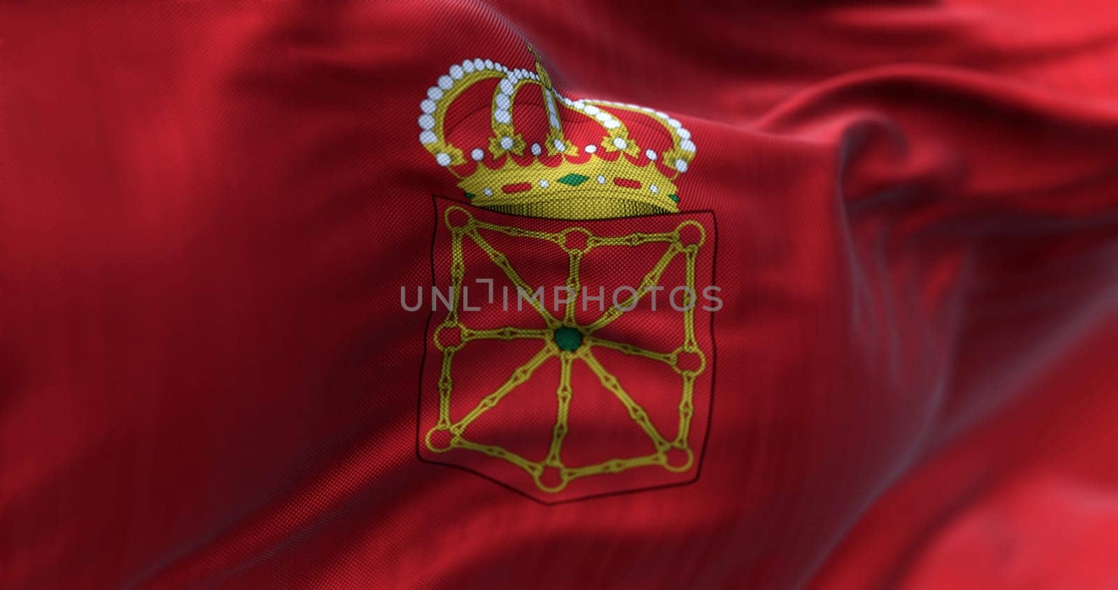 Close-up of Navarre flag waving. Autonomous community of Spain. Golden chains arranged against a red background. 3d illustration render. Selective focus. Close-up. Fluttering fabric