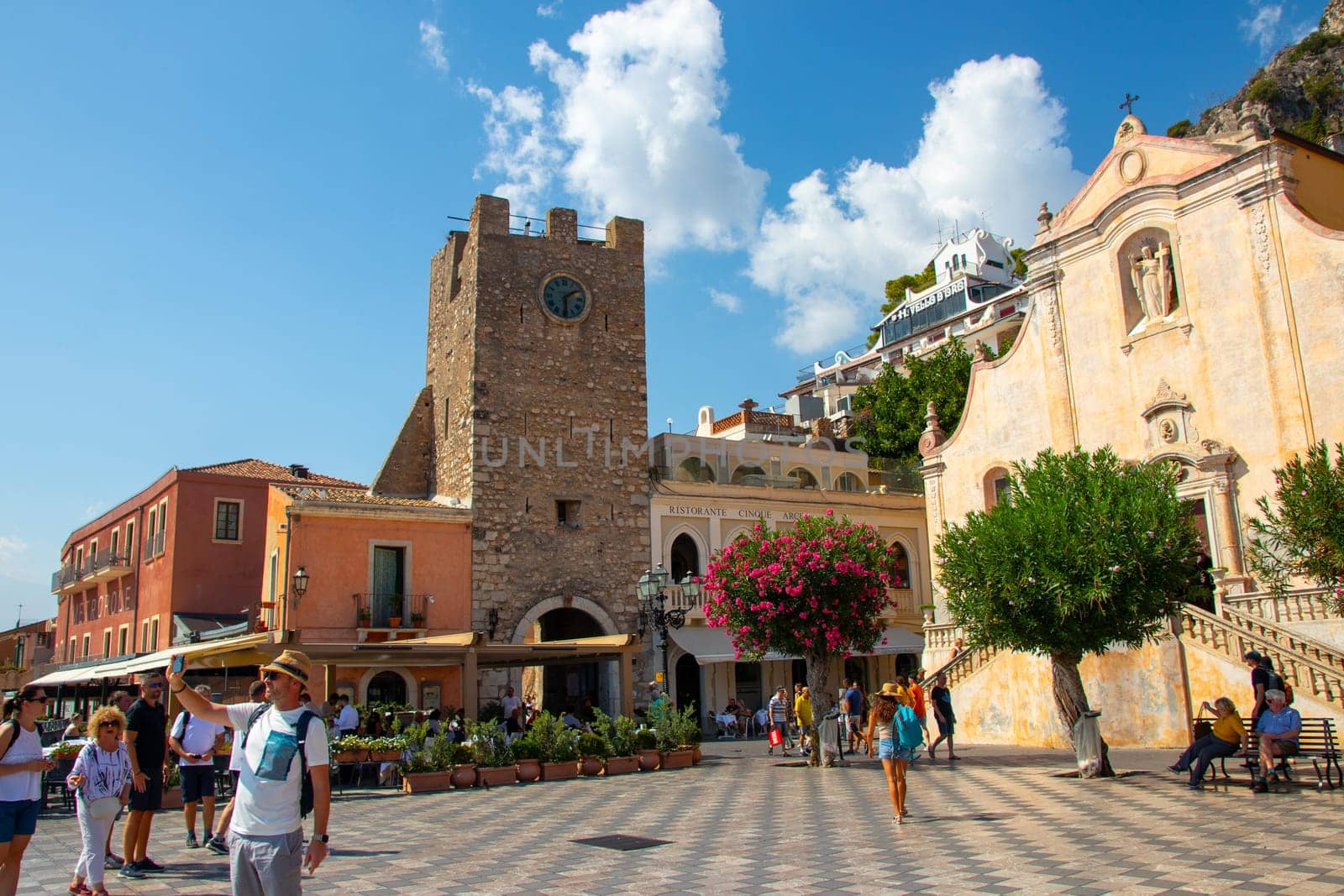 Sicily, Taormina, Italy - 28 September 2023. City views, facades, architecture and the most popular streets. Tourists at Mainsquare Piazza IX Aprile and San Giuseppe church.