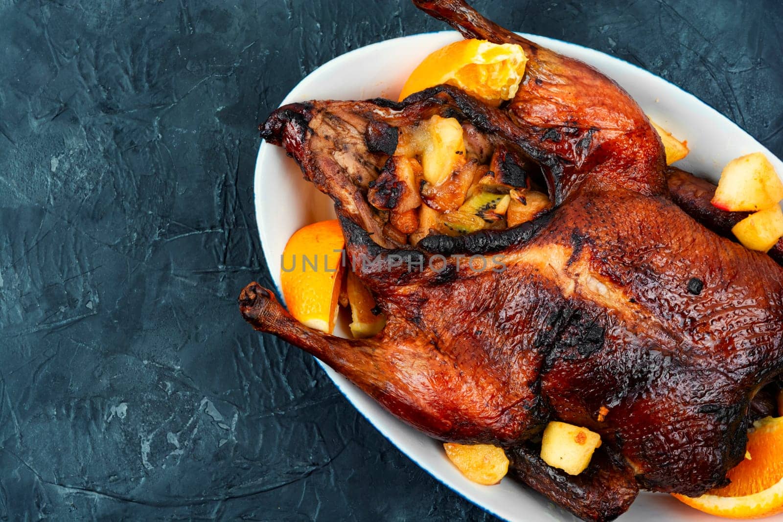 Whole duck baked with oranges and caramelized apples.