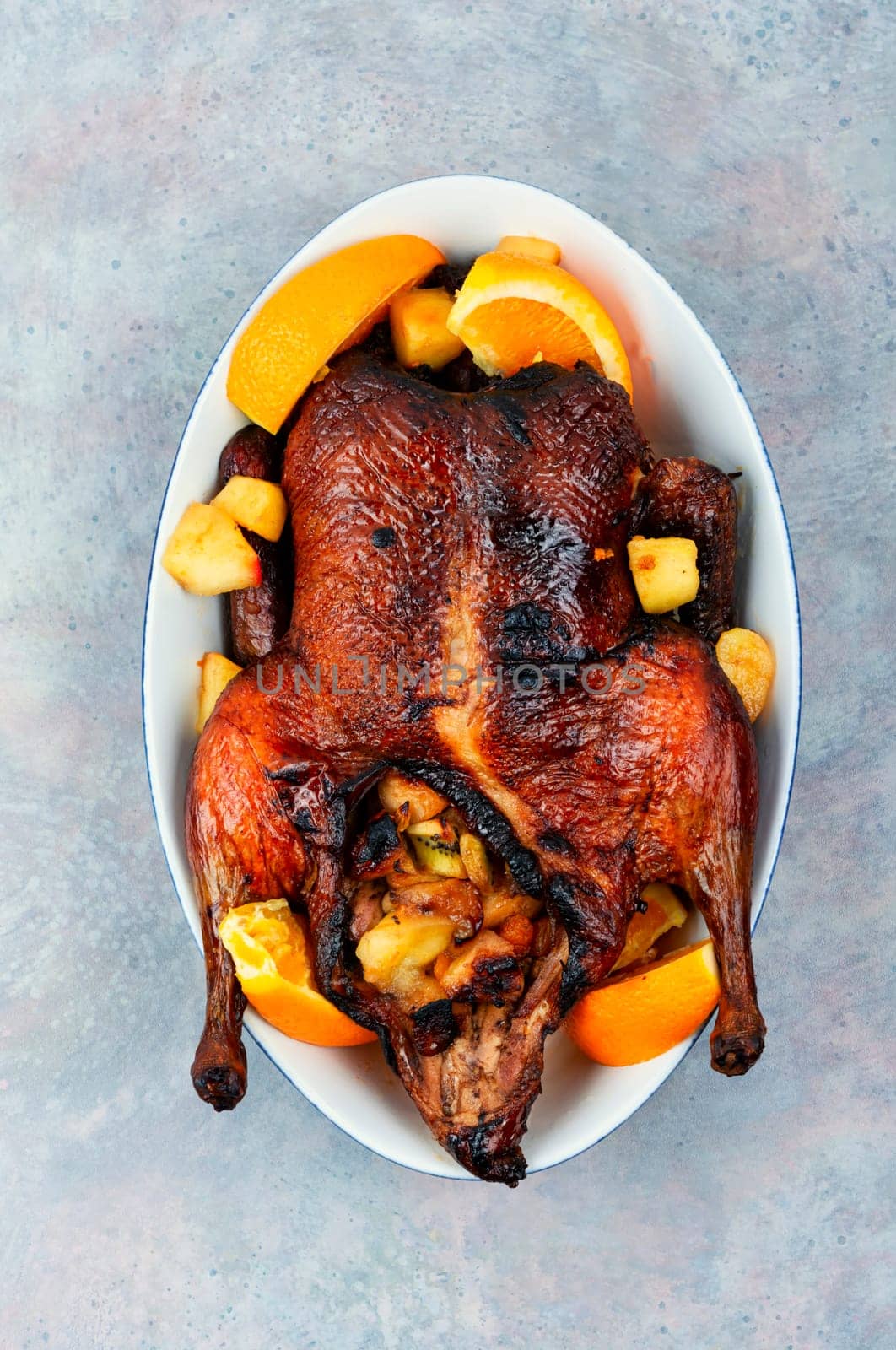 Whole duck baked with oranges and caramelized apples.