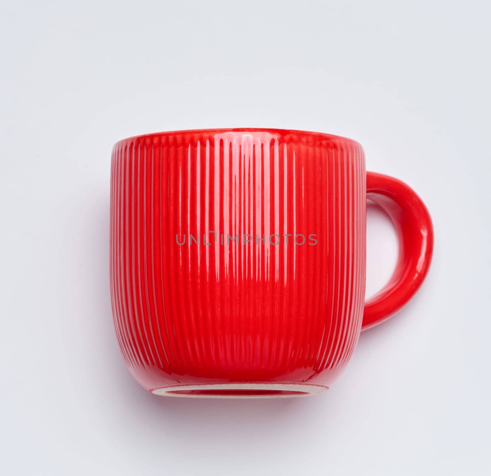 Red empty ceramic cup on white background