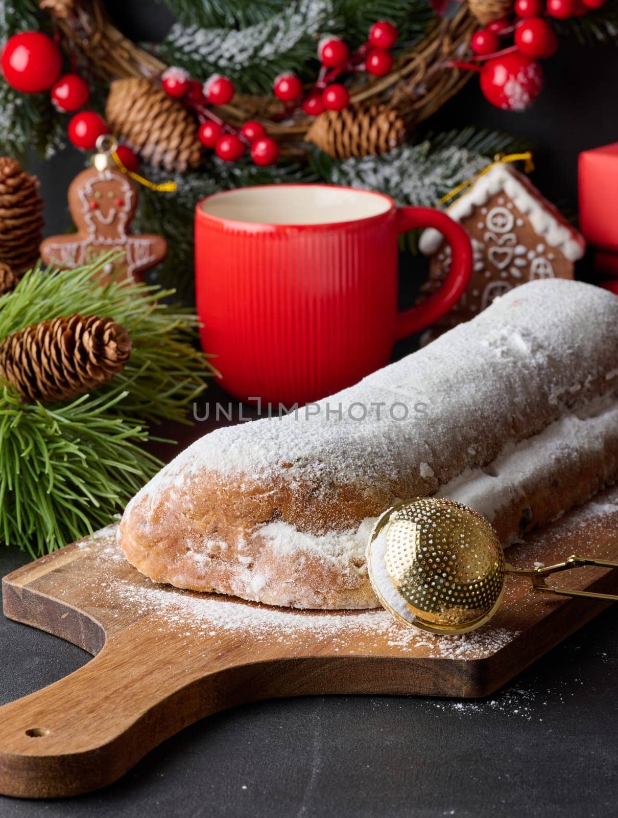 Christmas pastries stollen sprinkled with powdered sugar on the table, festive dessert