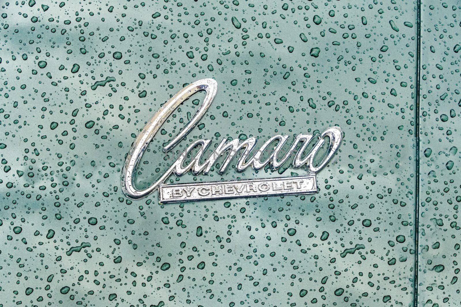 WETTENBERG, HESSE, GERMANY - 07 - 28 - 2023: CAMARO by Chevrolet Logo with raindrops in Detail on a traditional Car Show Golden Oldies.