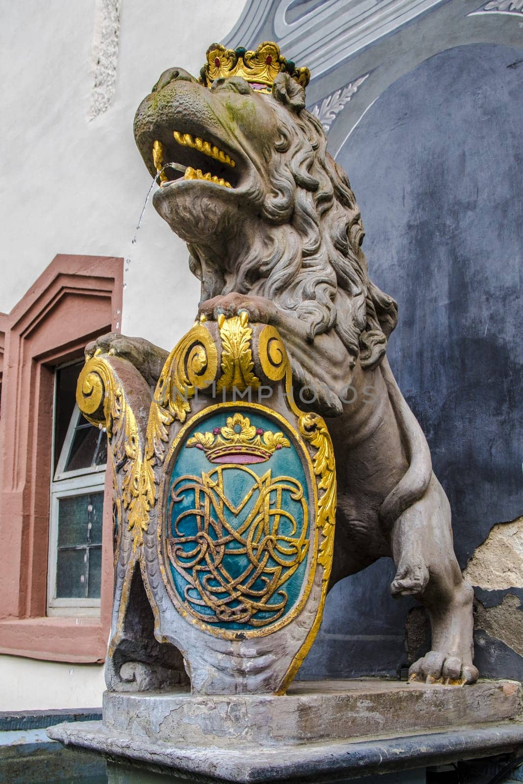 WEILBURG, GERMANY - 06-28-2023 - Fountain with coat of arms in the public courtyard of Weilburg Castle in Hesse, Germany
