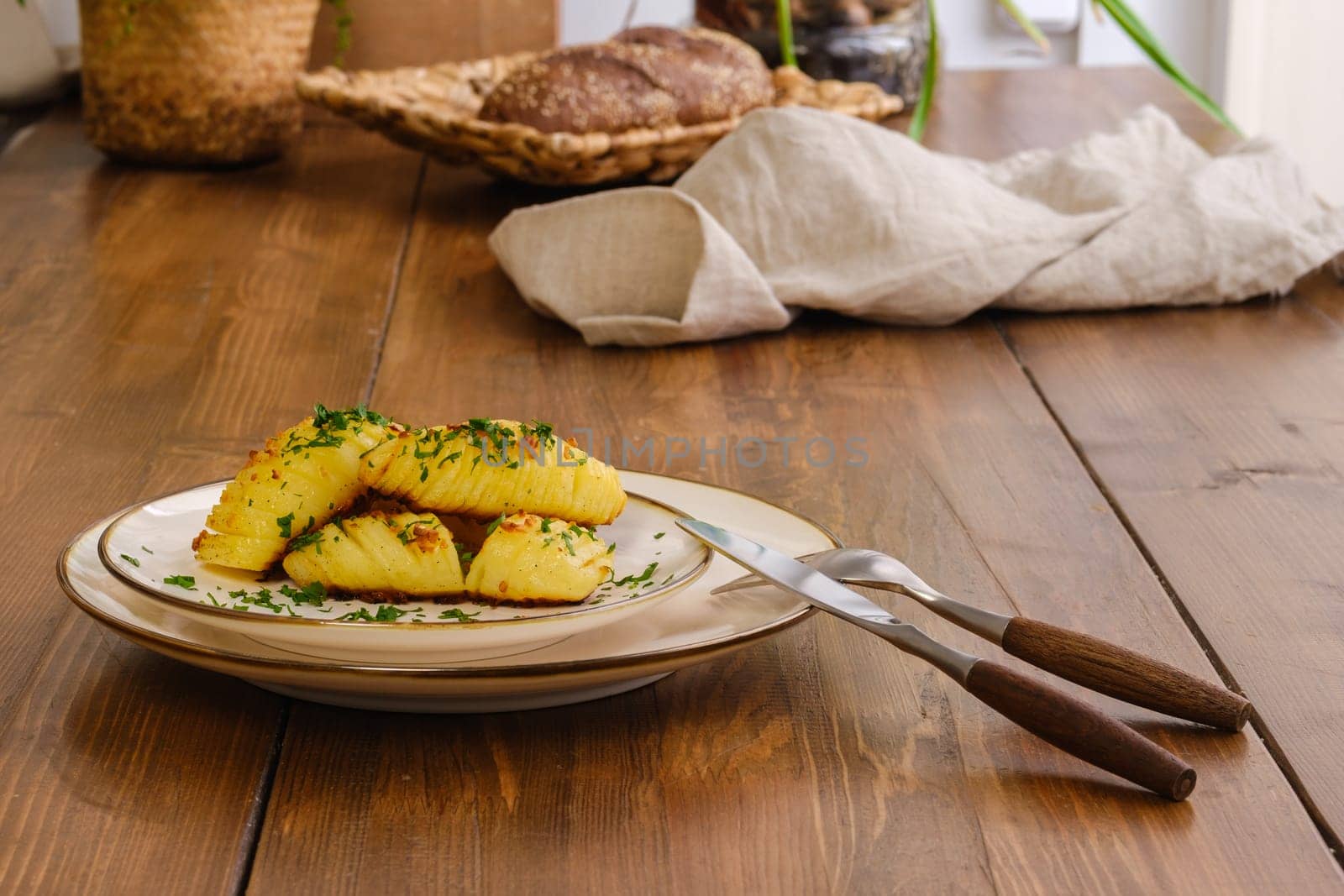 Baked hasselback potato served for dinner on a table