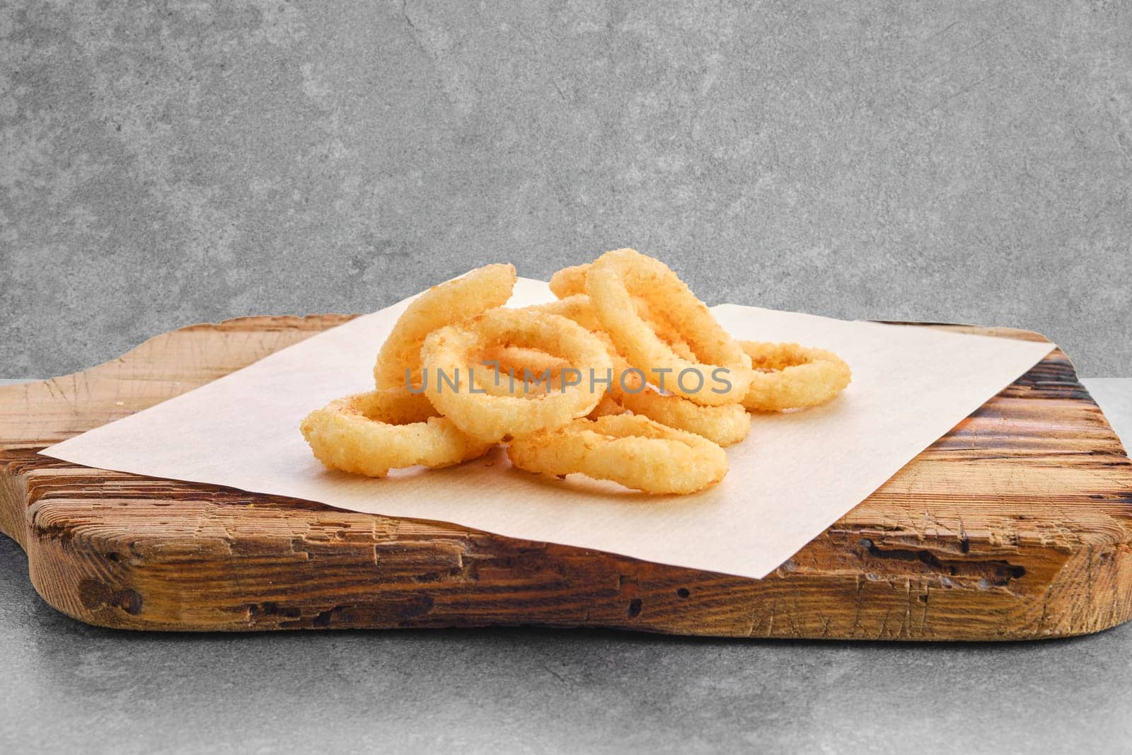 Deep fried spicy onion rings on parchment