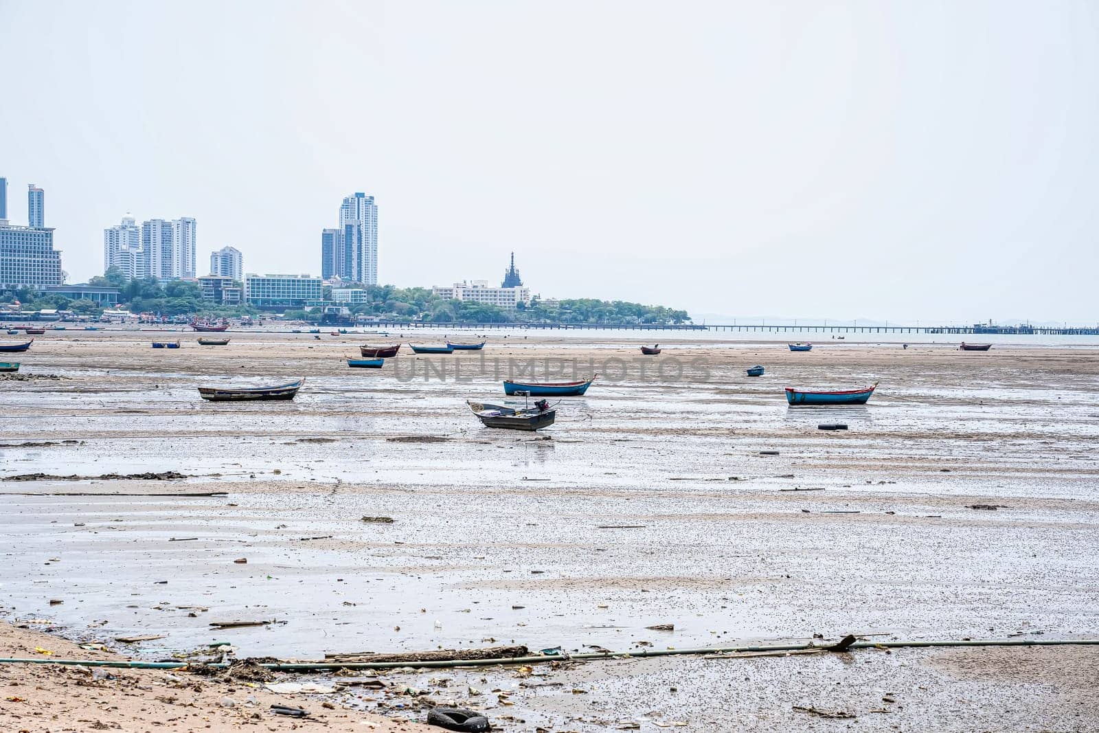 Many fishing boats are moored on the beach.