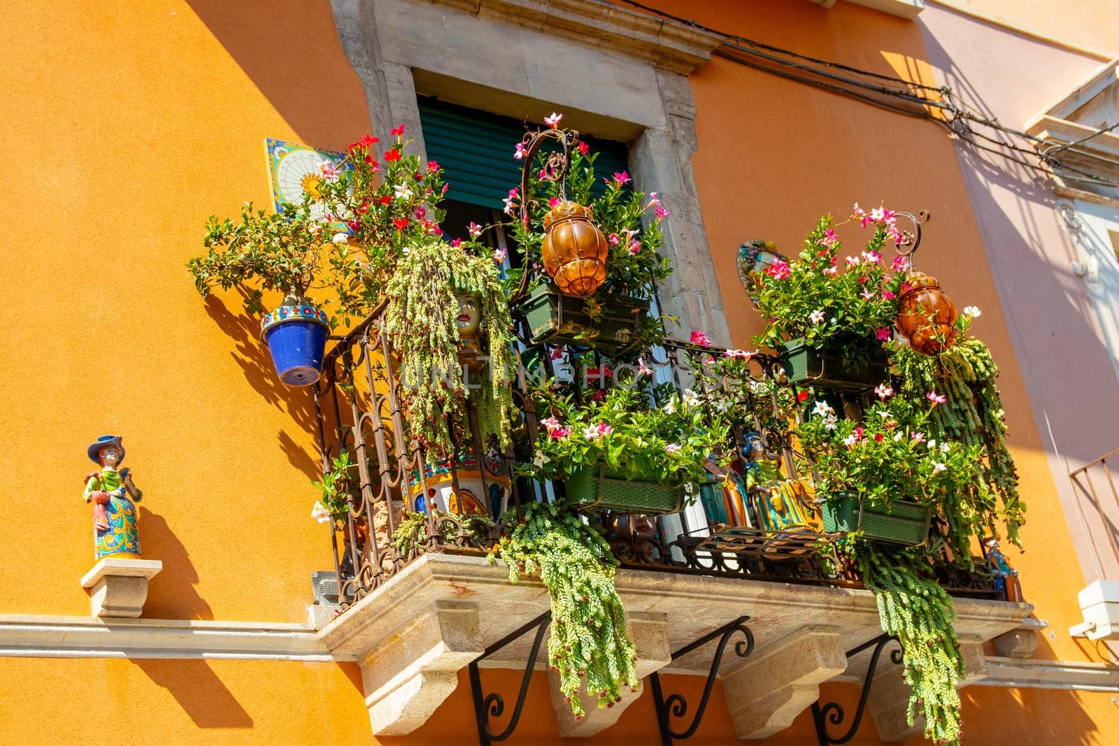 Sicily, Taormina, Italy - 28 September 2023. A beautifully decorated balcony on a townhouse in the main street Corso umberto in Taormina. City views and facades.