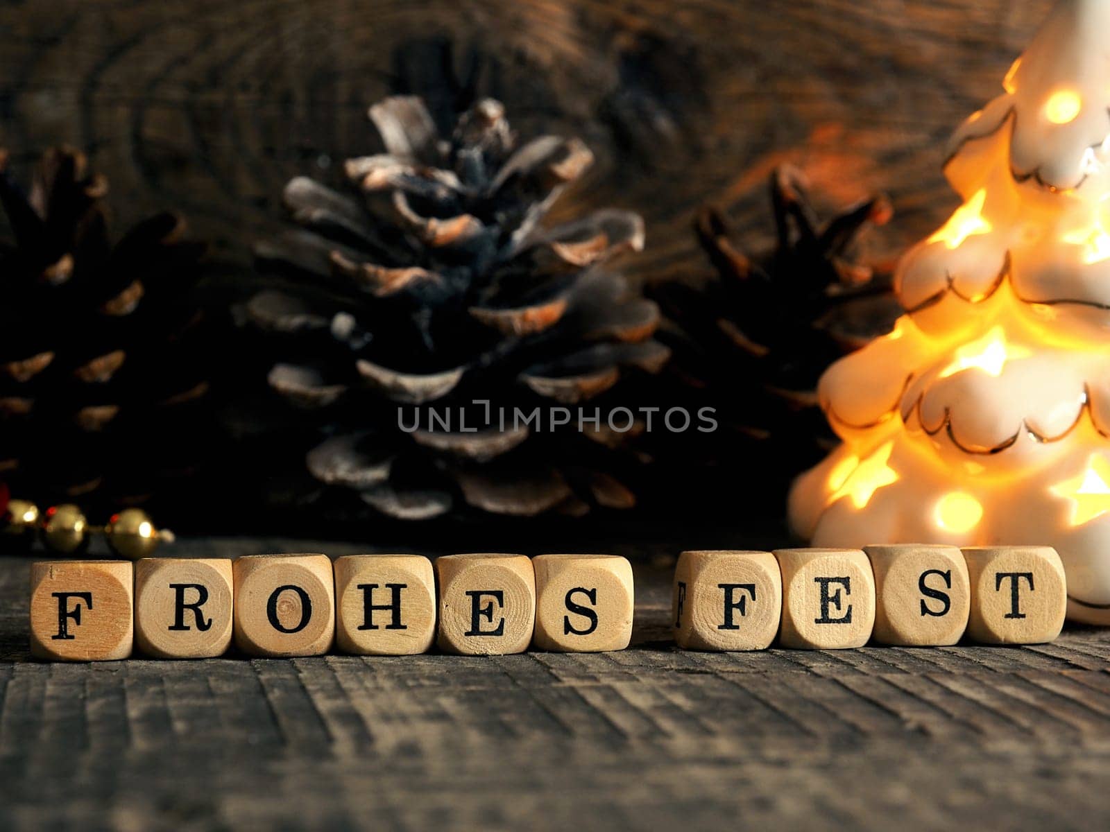 German Merry Christmas with wooden blocks and the inscrption Frohes fest, seasonal greetings
