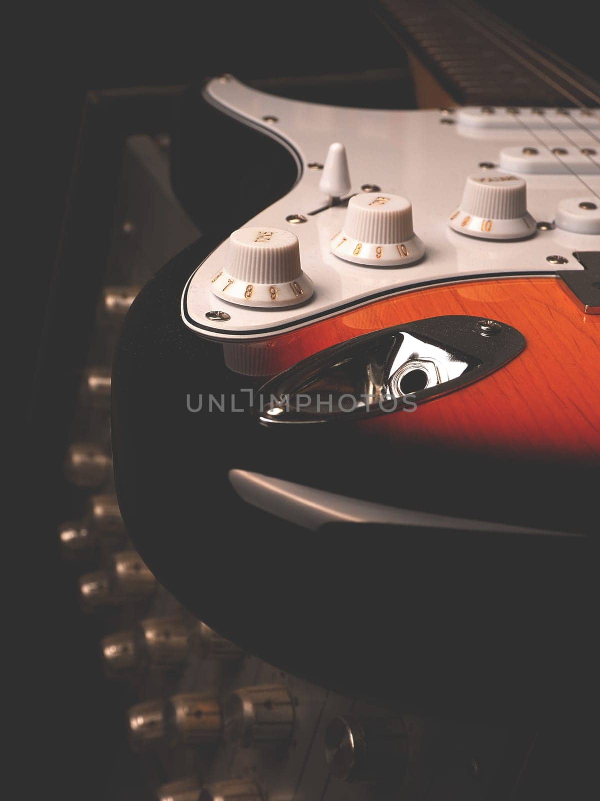 Vintage electric guitar on an old guitar amplifier in a studio