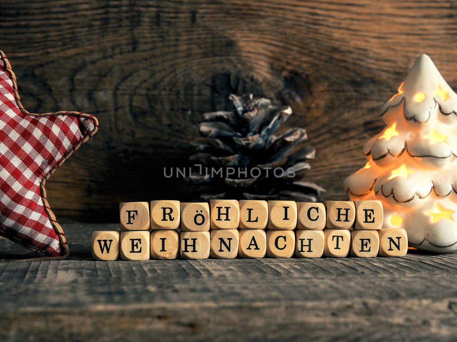 German Merry Christmas with wooden blocks and the inscrption Frohes fest, seasonal greetings