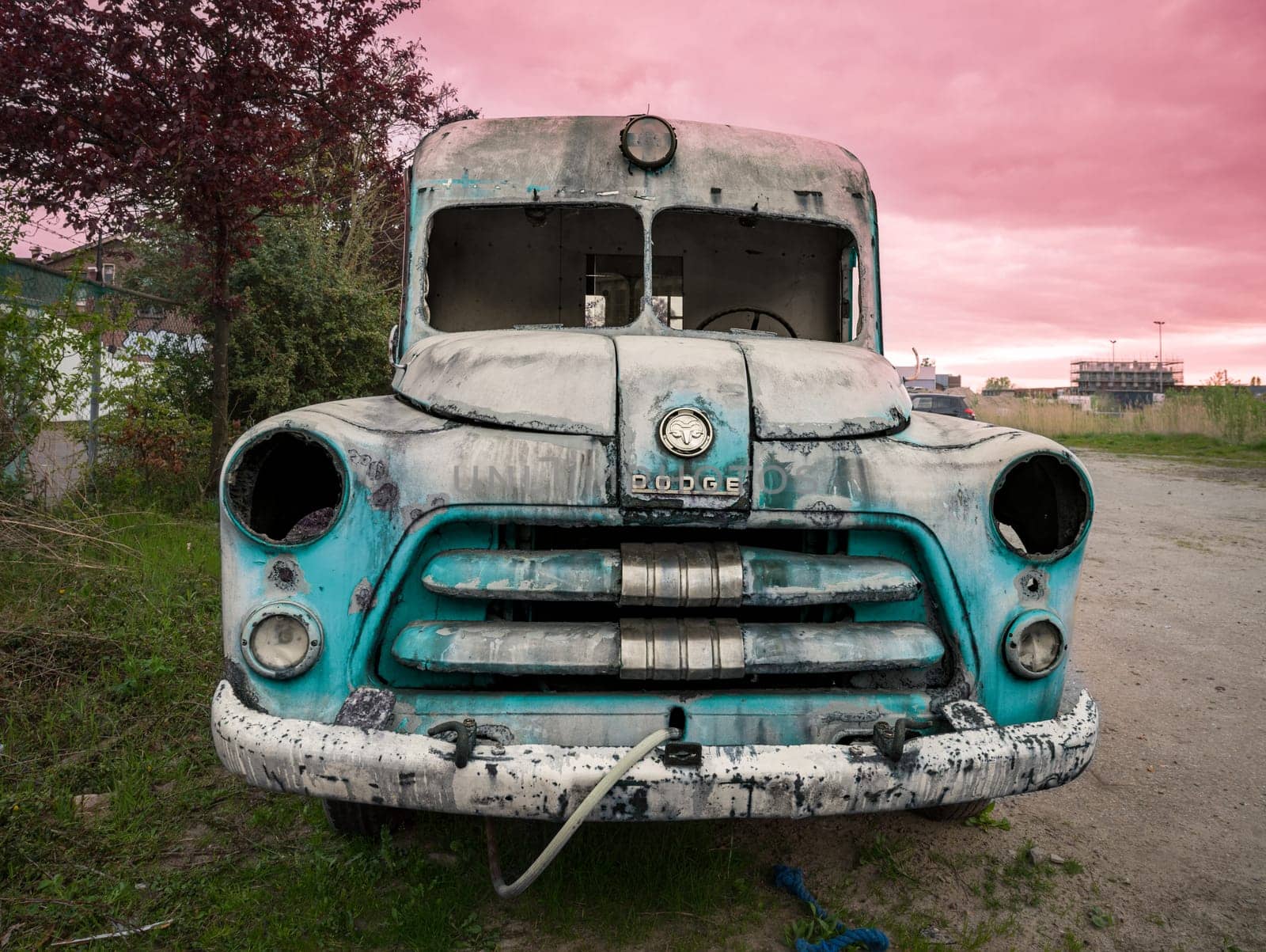 HENGELO, NETHERLANDS - MAY 2, 2023: Old and broken dodge ambulance car used as an art object