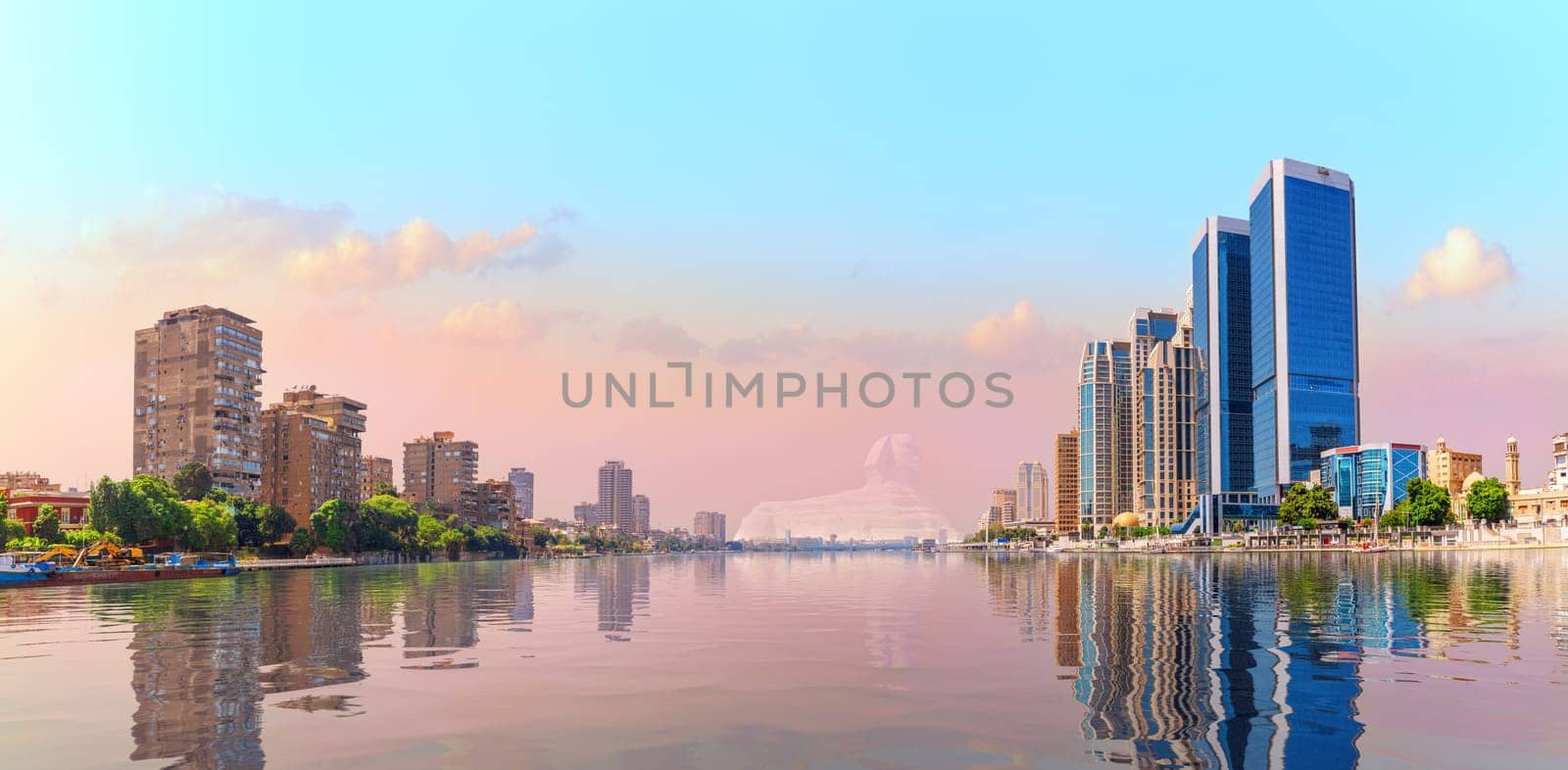 Cairo downtown reflecting in the waters of Nile river, beautiful sunset scenery, Egypt.