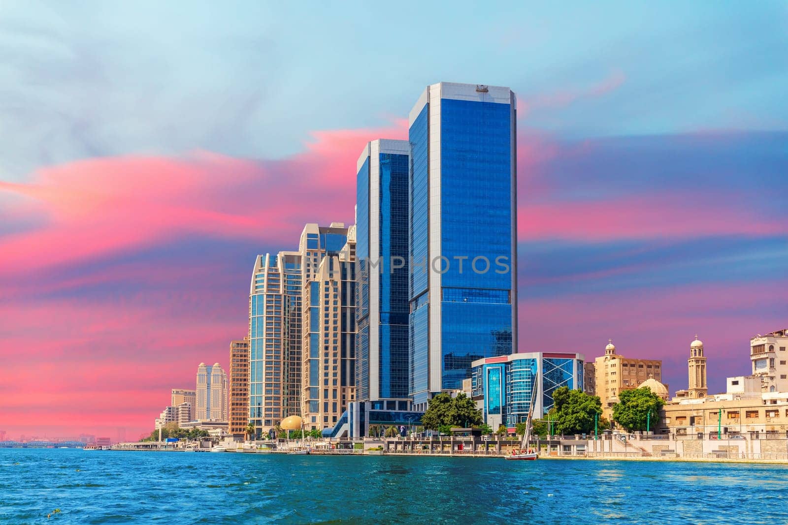 Skyscrapers of Cairo by the Nile river, great sunset view of the capital of Egypt.