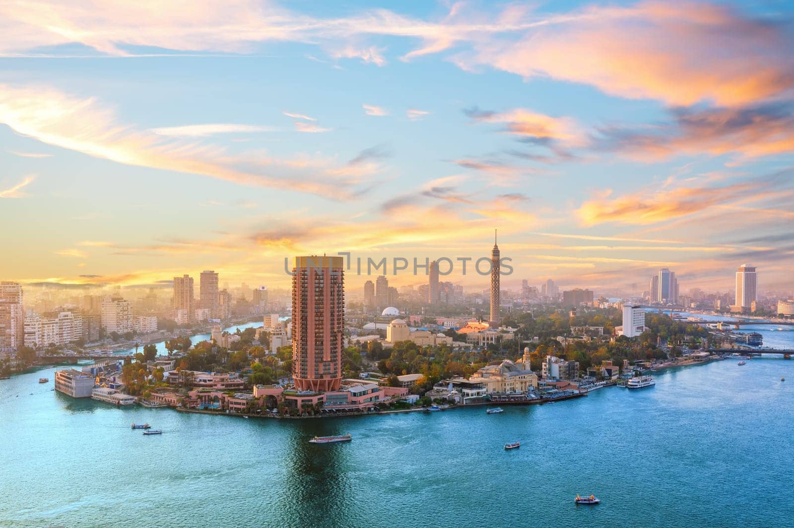 Sunset over the Nile river, fancy buildings and TV tower of Cairo, Egypt.