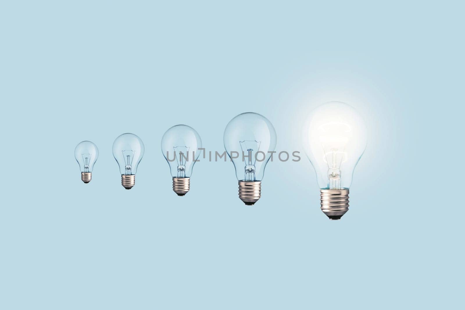 Creative light bulbs loading process and one glowing light bulb on a blue background. Creative idea, concept. Uploading a new idea. Project and success