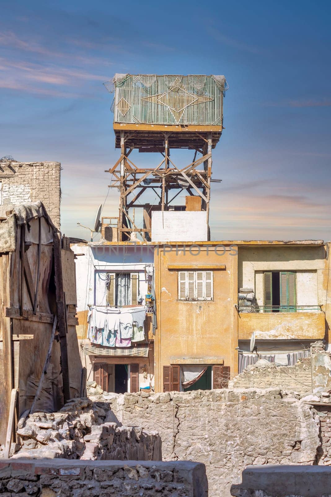 Wooden pigeon tower in a poor residential area in the middle of old, shabby buildings, one of the oldest methods of raising birds