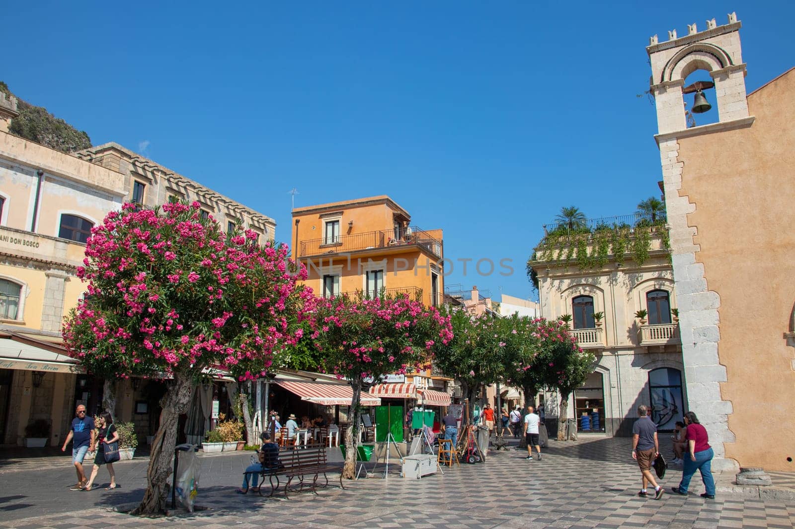 Sicily, Taormina, Italy - 28 September 2023. Tourists at Mainsquare Piazza IX Aprile and San Giuseppe church. City views, facades, architecture and the most popular streets.