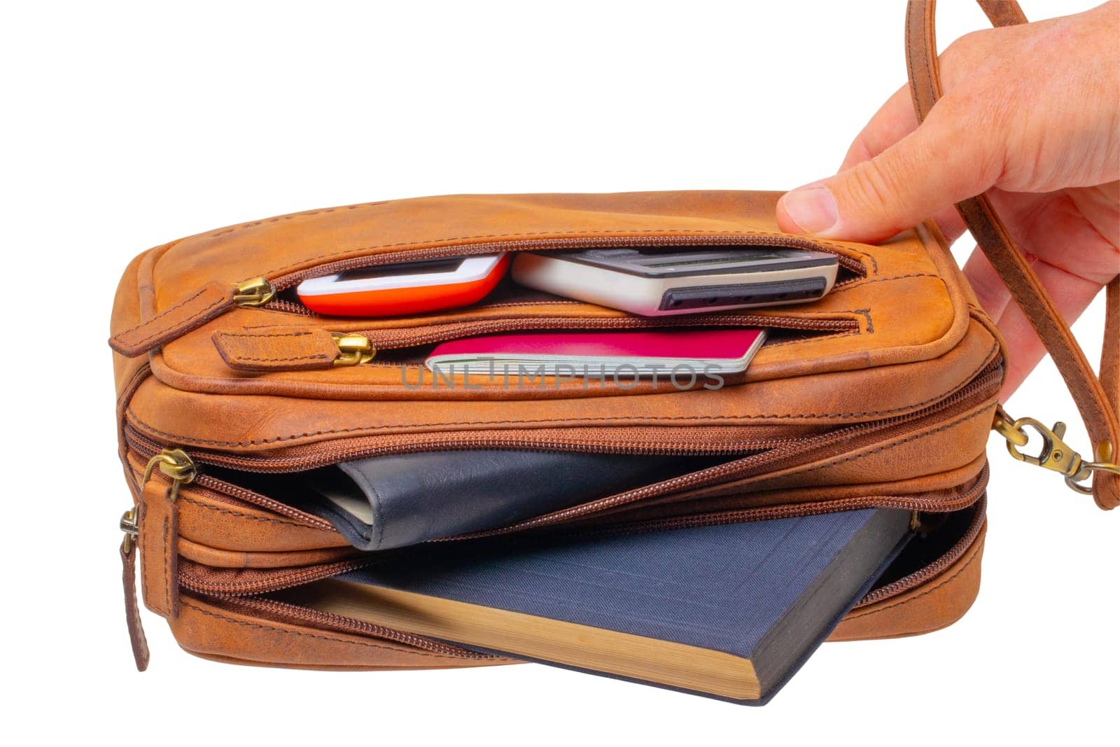 Leather handbag isolated. One hand holds a spacious brown luxury leather wrist bag. Fashionable businessman's bag or briefcase. Clipping Path.