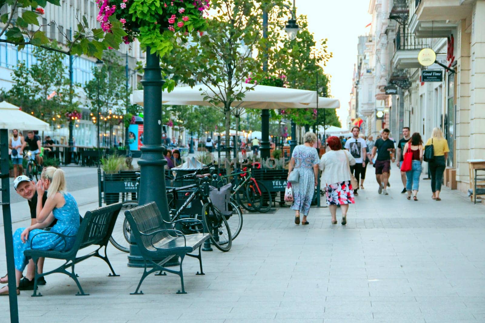 Central street of Lodz. People walking along city street. View of main street of Lodz. Central street of Lodz Piotrkowska. Cityscape. Urban panorama