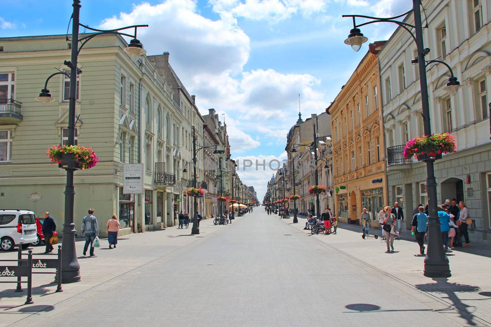 Central street of Lodz. People walking along city street. View of main street of Lodz. Central street of Lodz Piotrkowska. Cityscape. Urban panorama