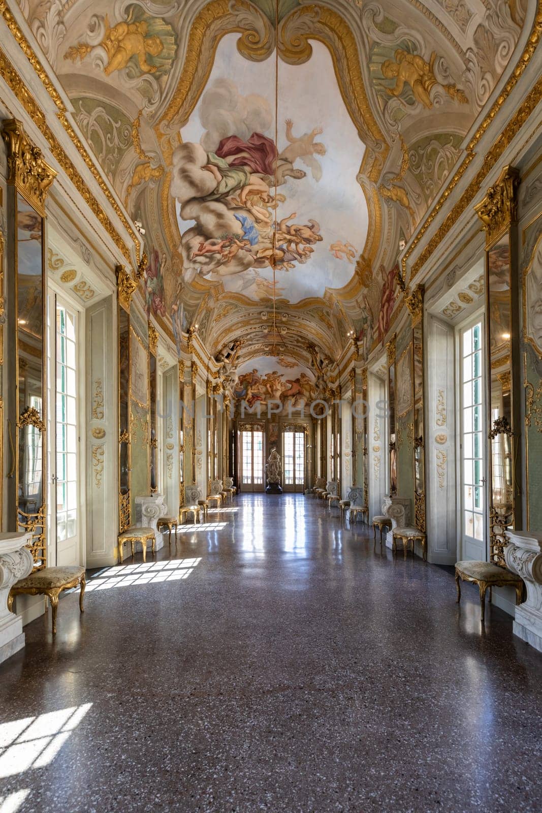 Genova, Italy - 6 August 2023: Royal Palace museum interior. Luxury marble, gallery with windows and mirrors.