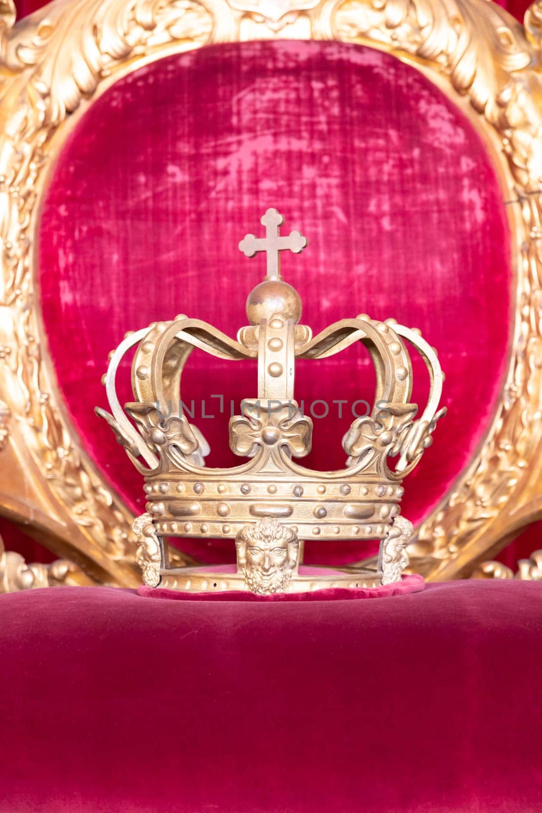 Ancient crown on red velvet. Antique symbol of authority, luxury, monarchy, nobility, success
