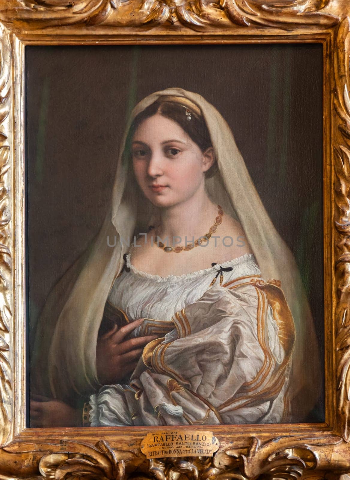 Florence, Italy - 23 September 2023: Pitti Palace antique painting museum. The vailed woman - La velata - by Raphael - Raffaello Sanzio, 1514.