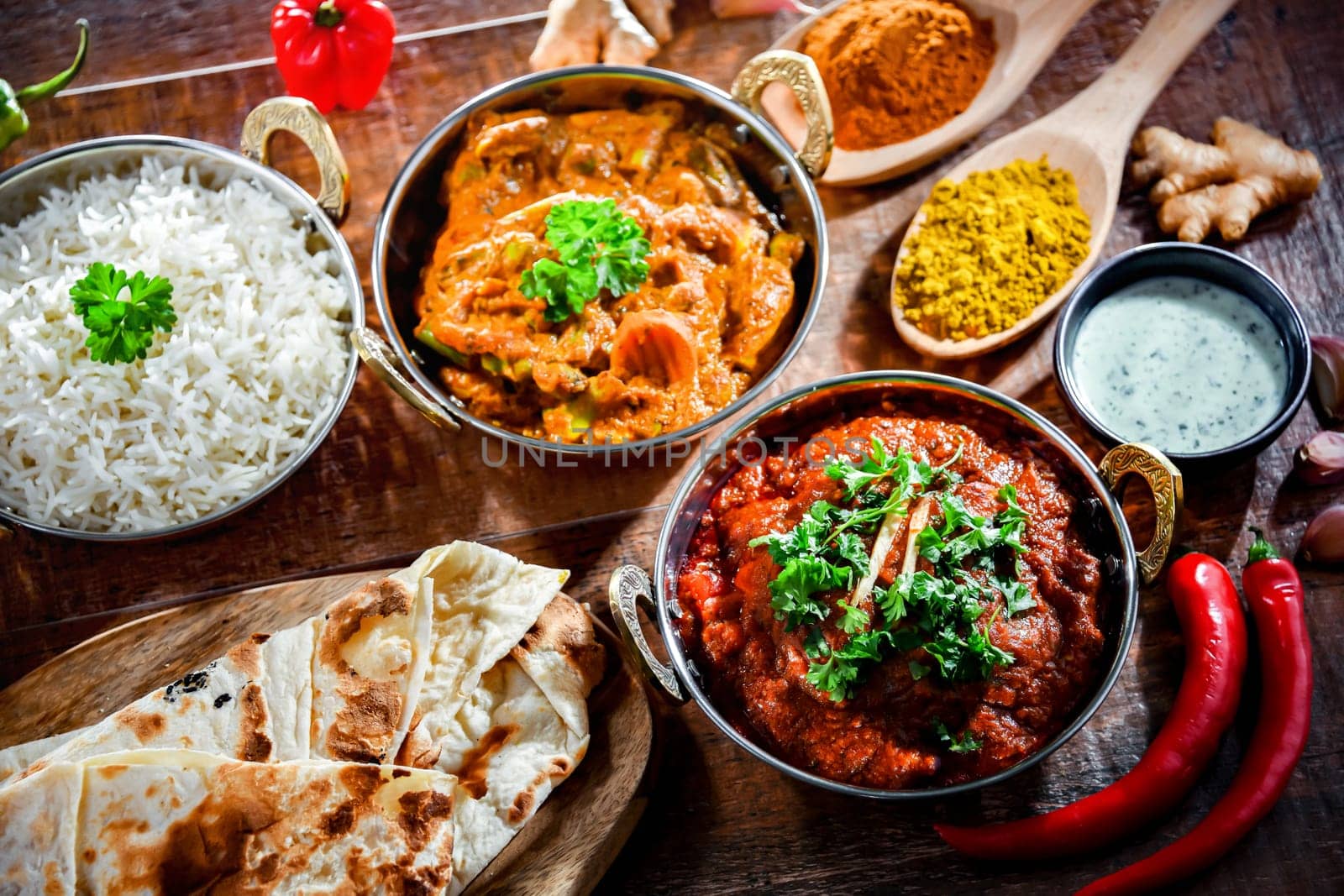 Hot madras paneer and vegetable masala with basmati rice served in original indian karahi pots.