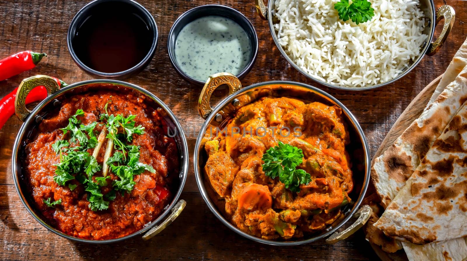 Hot madras paneer and vegetable masala with basmati rice served in original indian karahi pots.