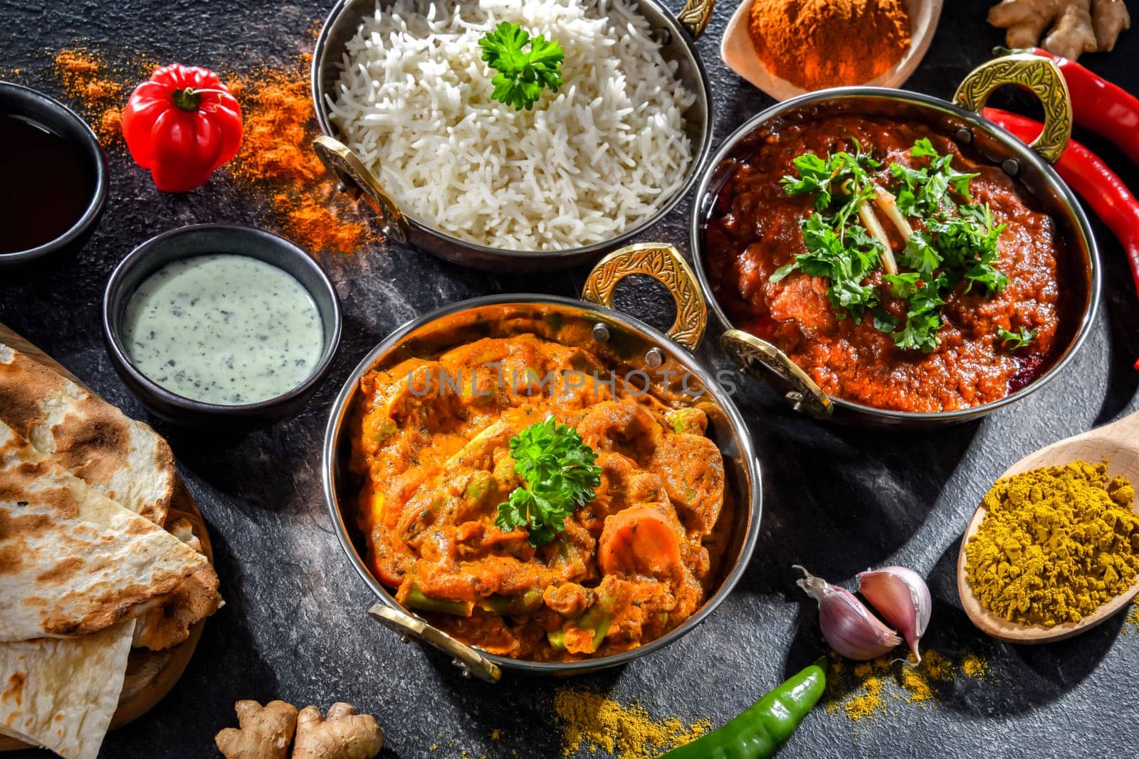 Hot madras paneer and vegetable masala with basmati rice served in original indian karahi pots.