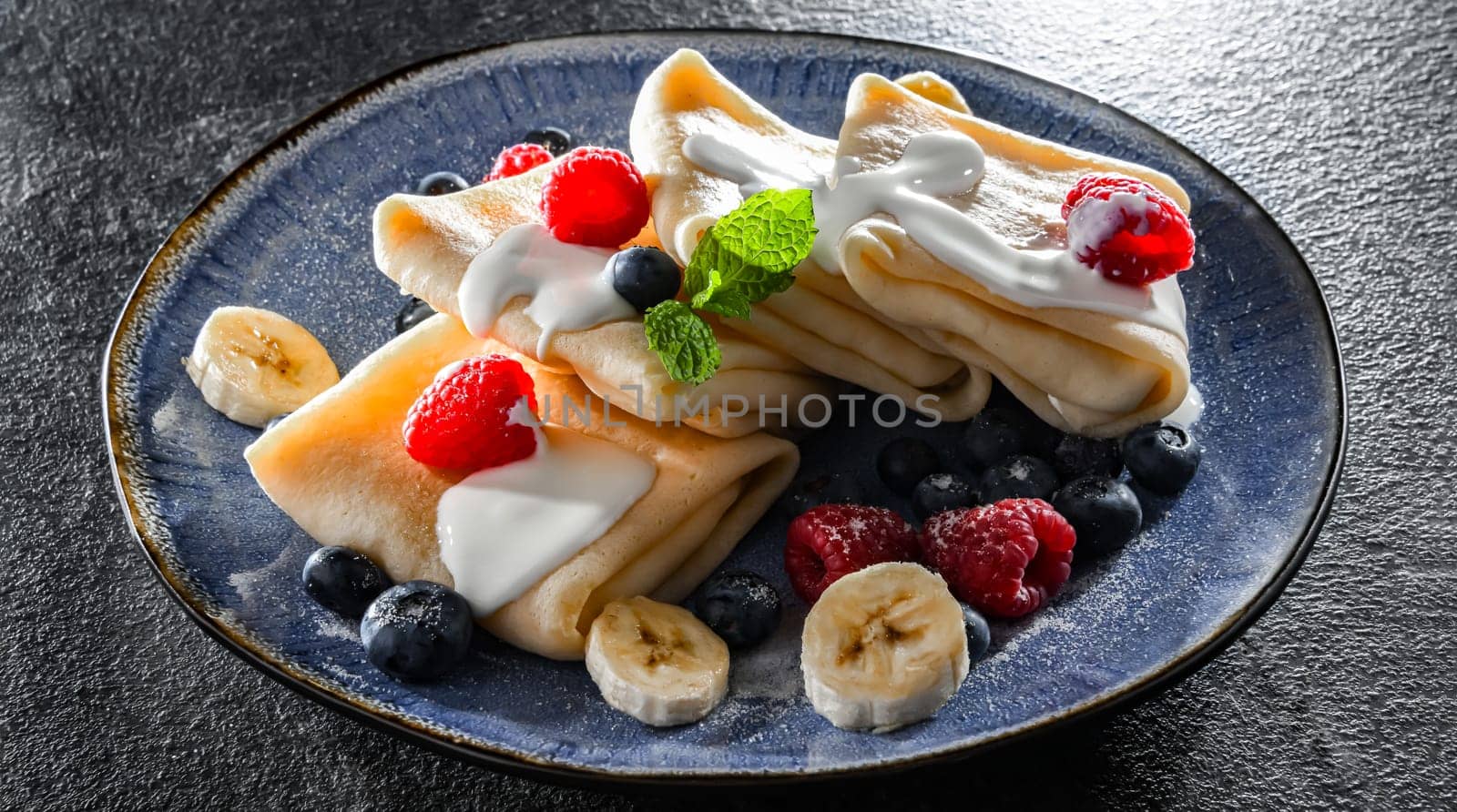 A plate of home-made Polish pancakes filled with sweet cottage cheese