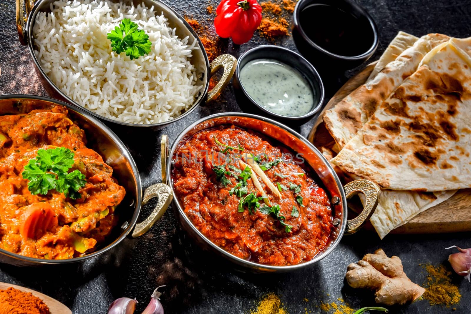 Hot madras paneer and vegetable masala with basmati rice served in original indian karahi pots.