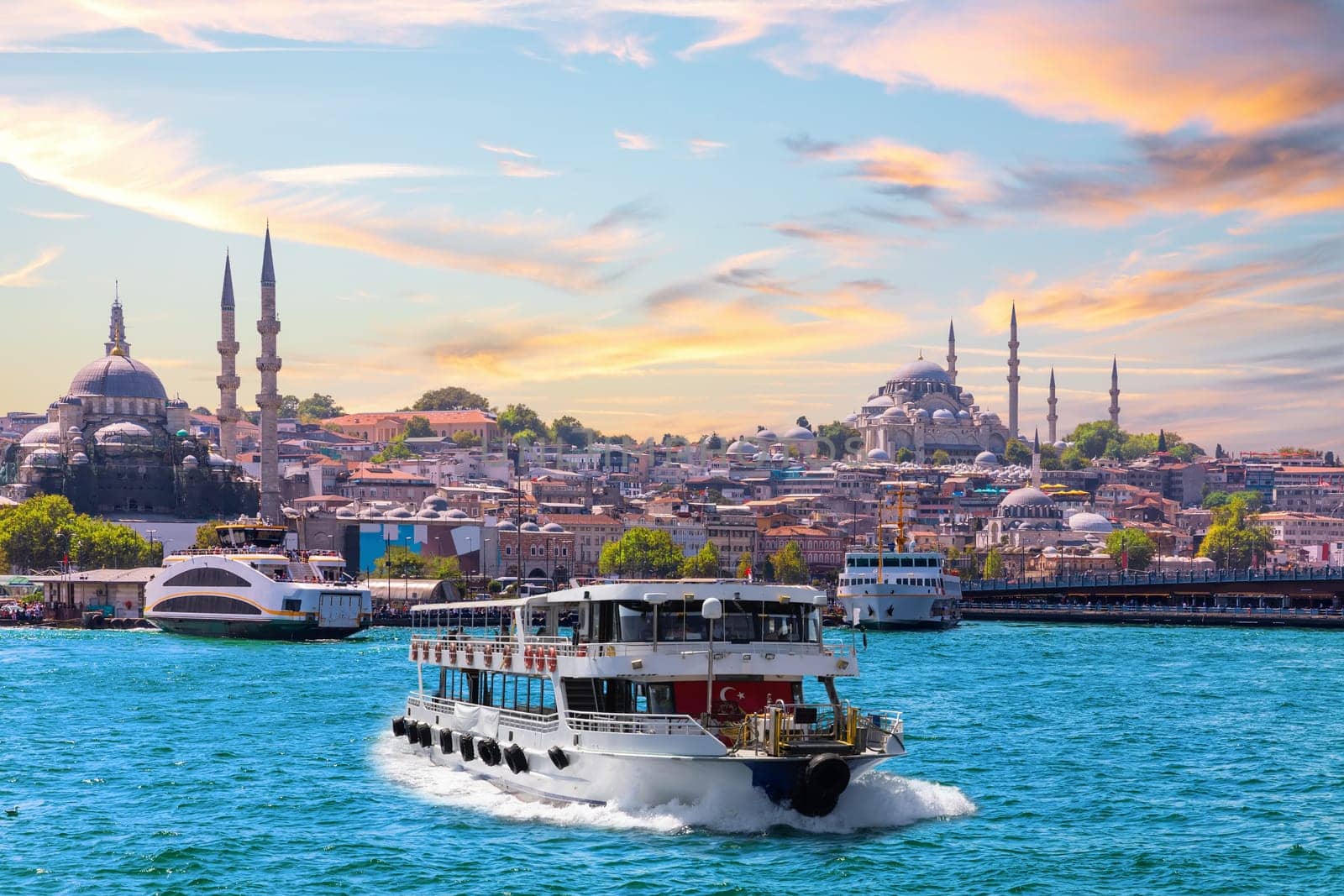 Famous Suleymaniye and Rustem Pasha Mosques and the cruise boat on the Bosphorus, popular place of Istanbul, Turkey.